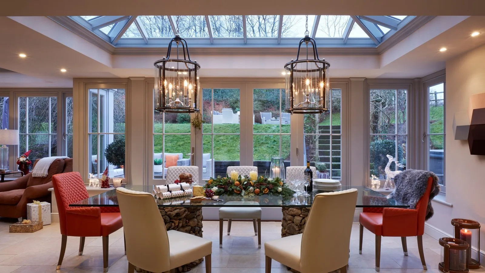 A grand open-plan kitchen and orangery with pendant lanterns and a dining area - Atlantic Interiors interior design, Kent