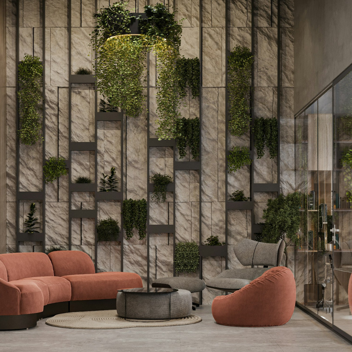 A dramatic commercial interior with a full-height living plant wall, natural stone cladding, terracotta modular sofa and a hanging pendant light - commercial interior design by Atlantic Interiors